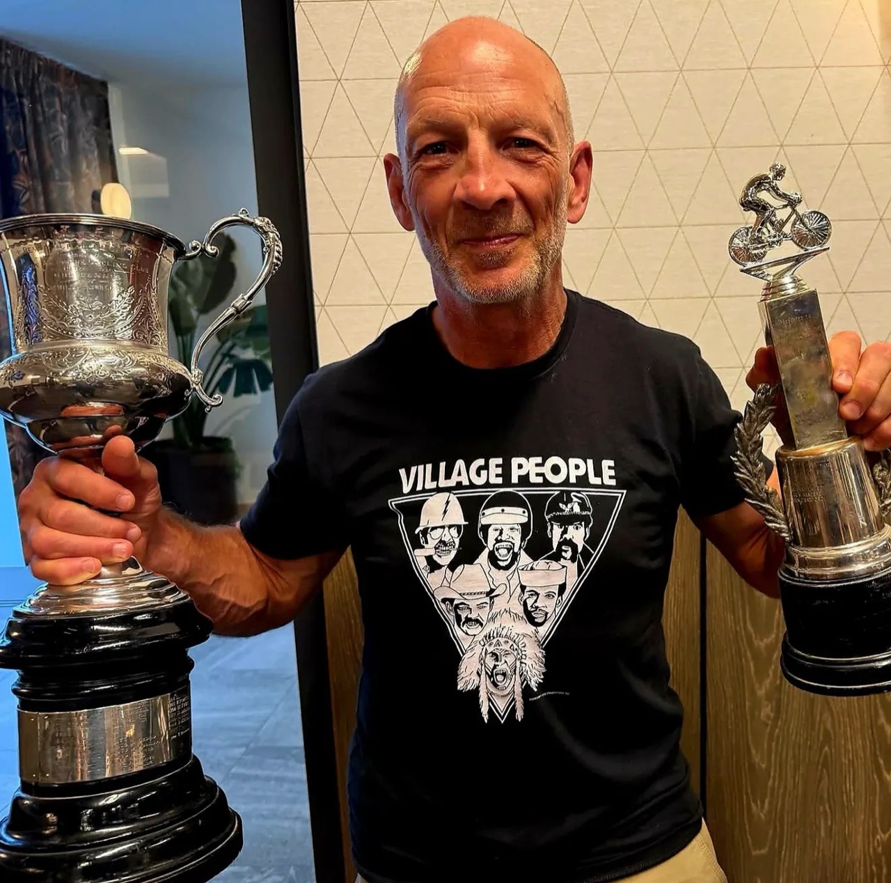 Andy Beale smiling with his cycling trophies